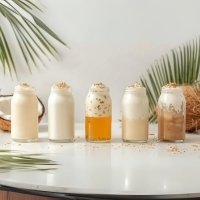 Creative coconut milk drinks with nata de coco in various flavors, garnished with tropical toppings